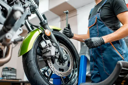 a bike mechanic of bikepromech, who is repairing a bike.