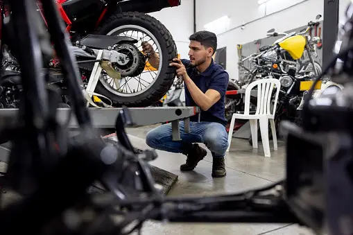 A bike mechanic servicing the bike